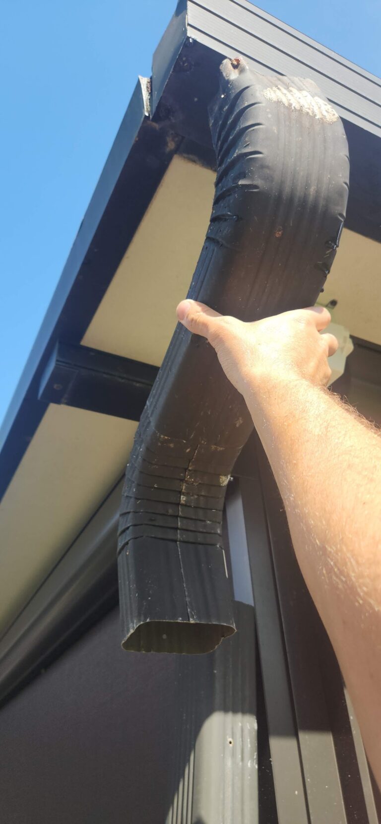 Gutter repair and downspout replacement on residential home in Sarasota Florida