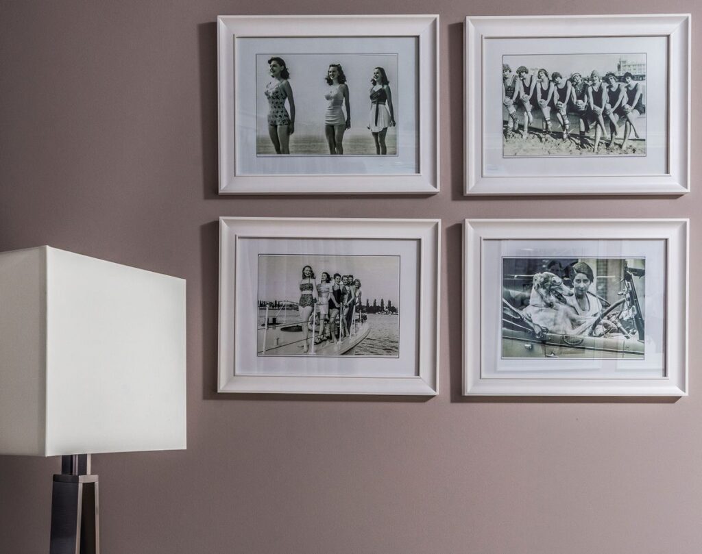 Balanced gallery wall of framed photos and art with even spacing