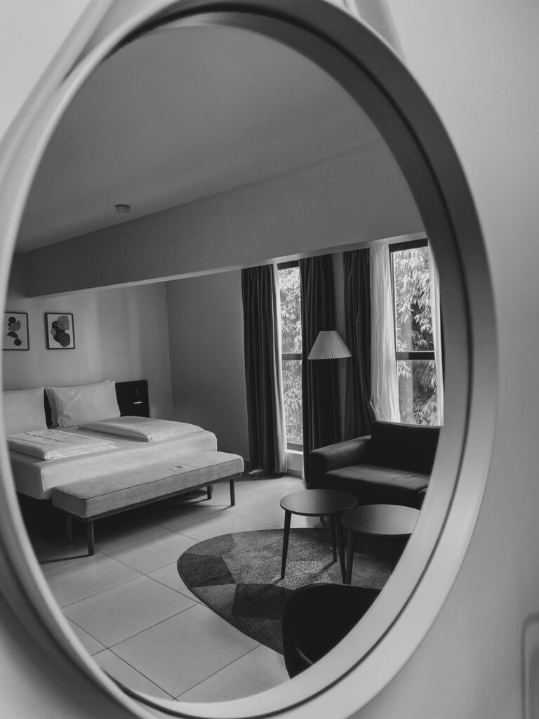 Large decorative wall mirror securely mounted as a statement piece
