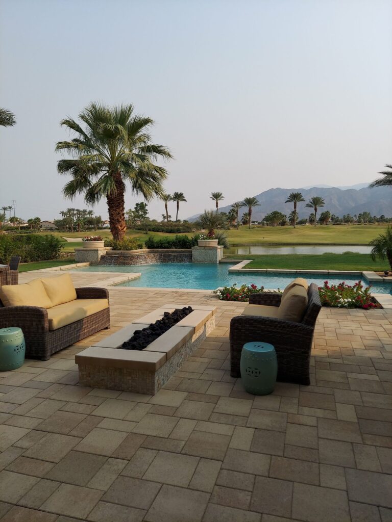 Level paver poolside patio with palm trees in a Florida backyard