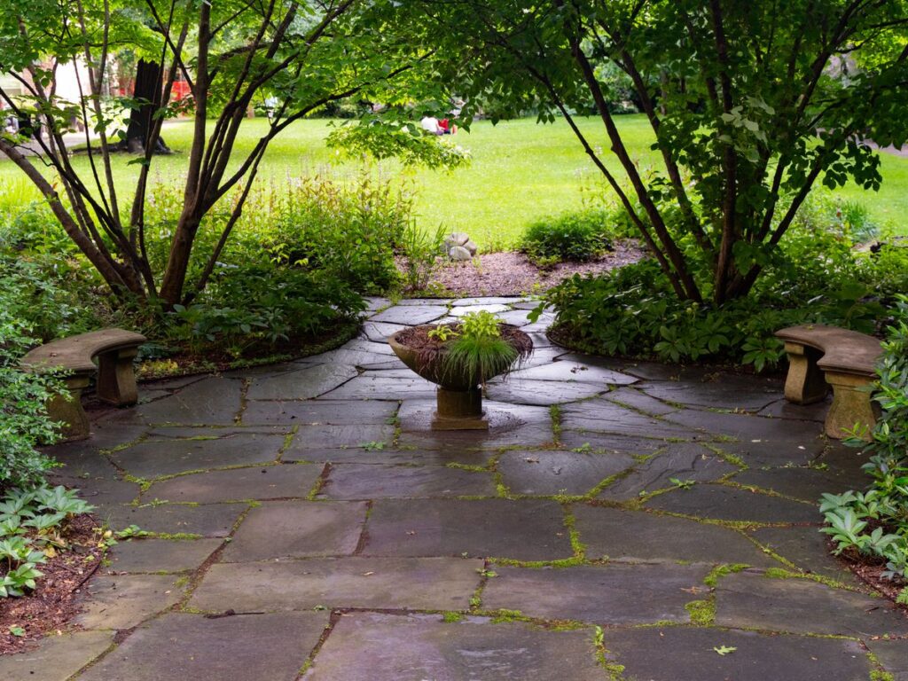 Tranquil stone paver patio surrounded by greenery