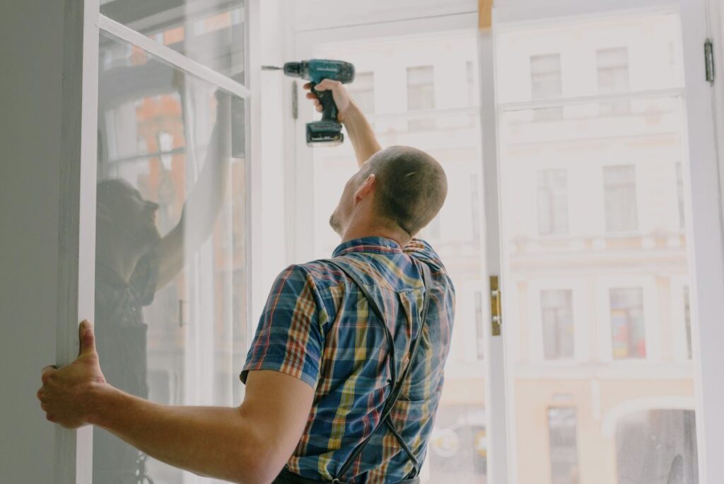 Handyman anchoring window track hardware with a drill