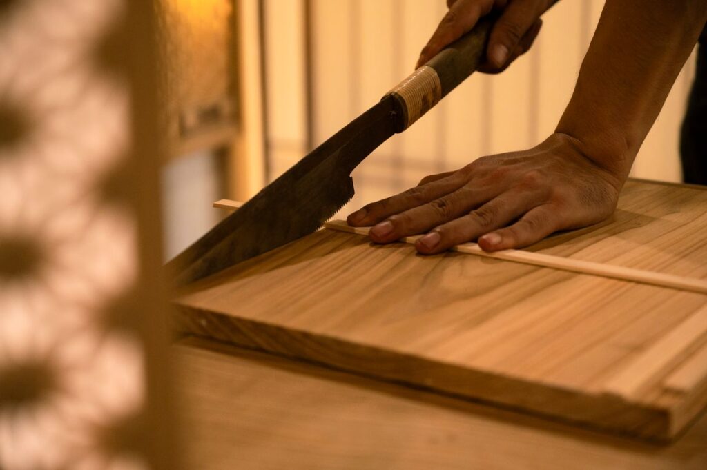 Carpenter precisely cutting trim molding for a clean baseboard fit