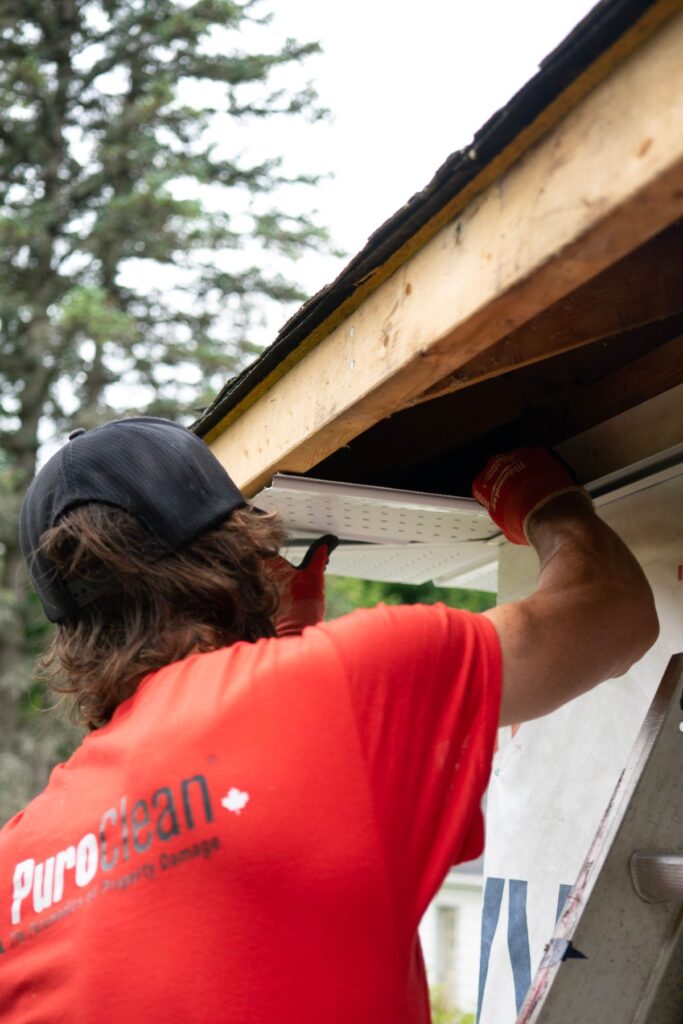 Installing gutter and fascia along a home roofline