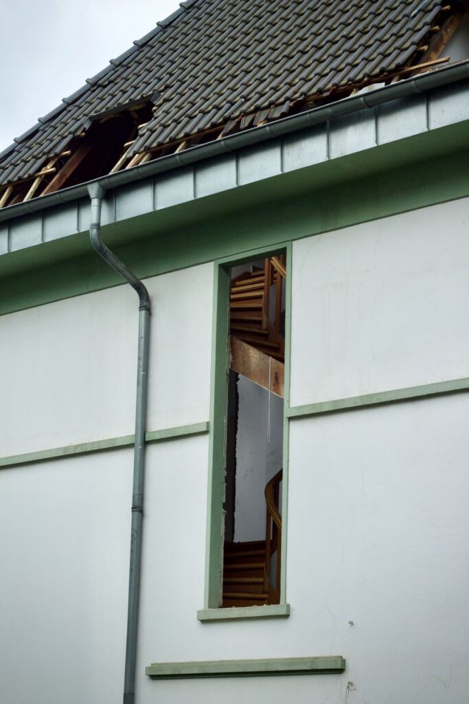Weather-damaged home exterior needing trim and fascia repair