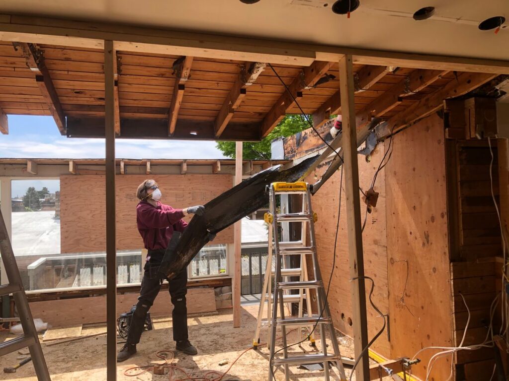 Handyman performing controlled interior demolition during a home renovation