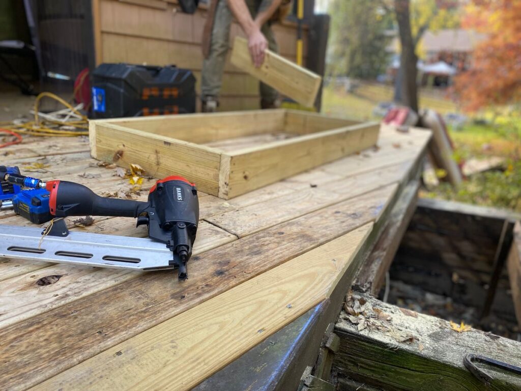 Carpenter fastening interior trim with a pneumatic nail gun