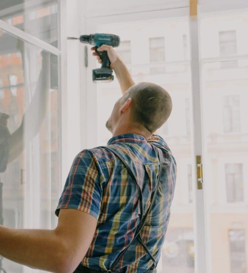Handyman anchoring window track hardware with a drill